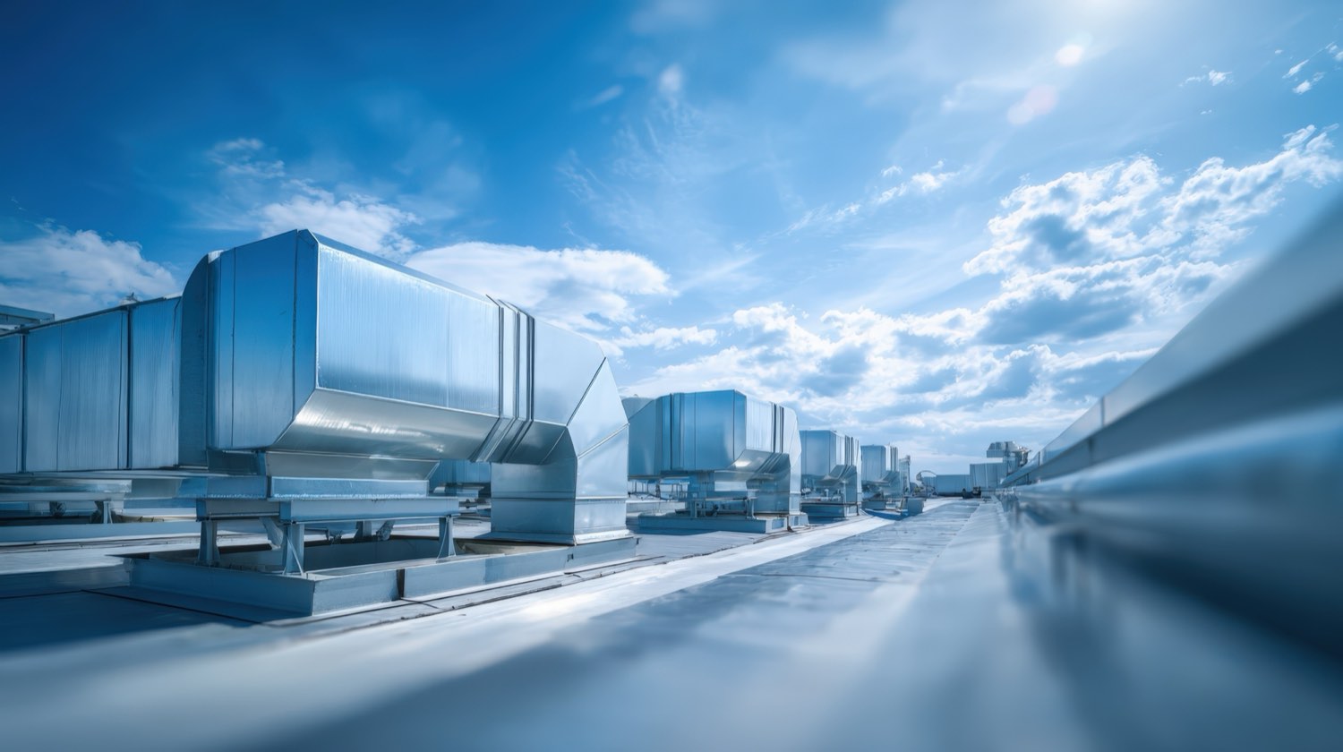 Rooftop commercial HVAC ventilation system against a blue sky
